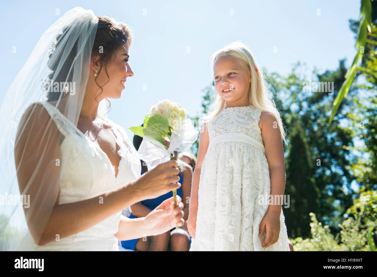 A bride and a young bridesmaid on the day of her wedding Stock Photo