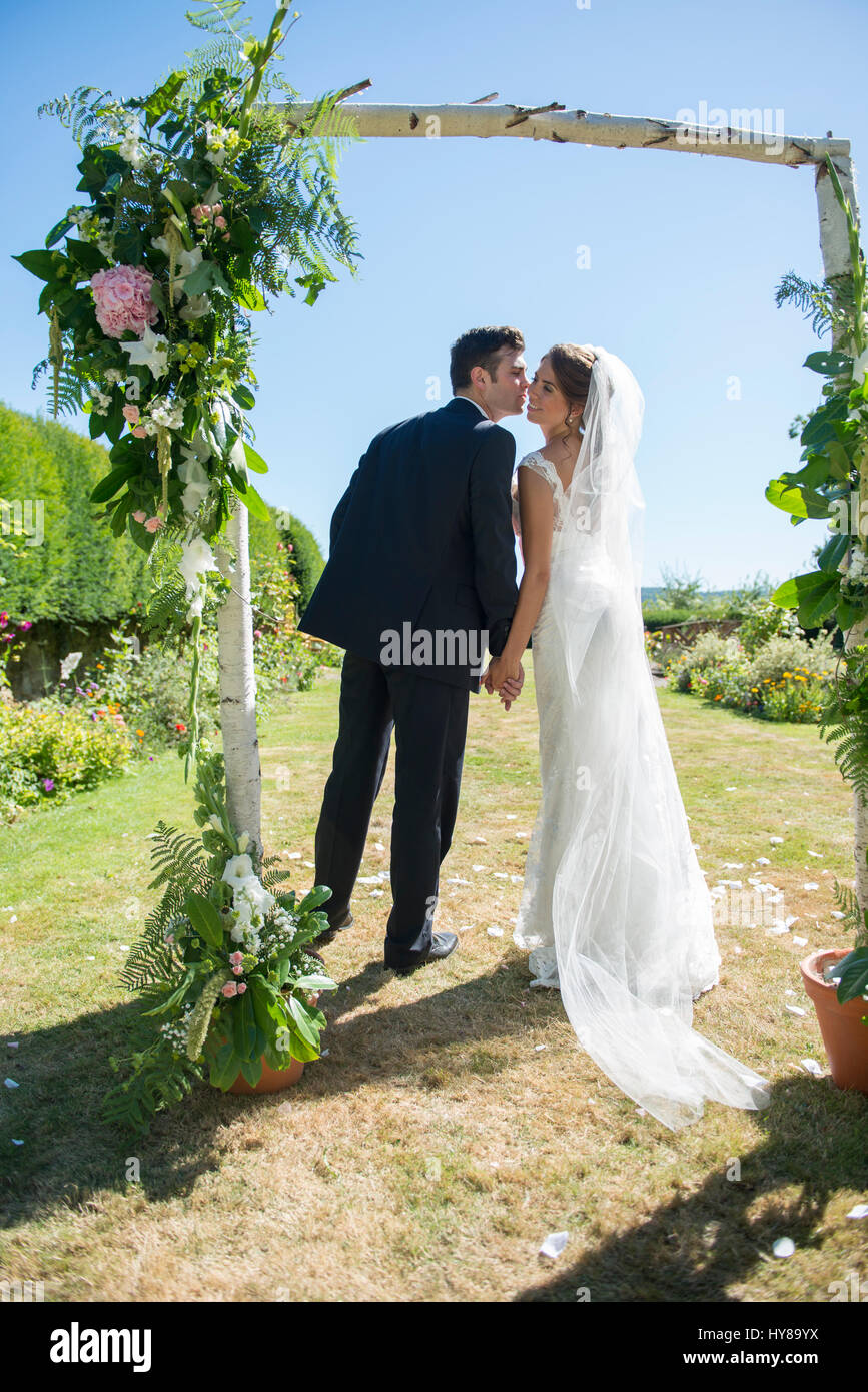 A bride and groom steal a kiss on their wedding day Stock Photo - Alamy