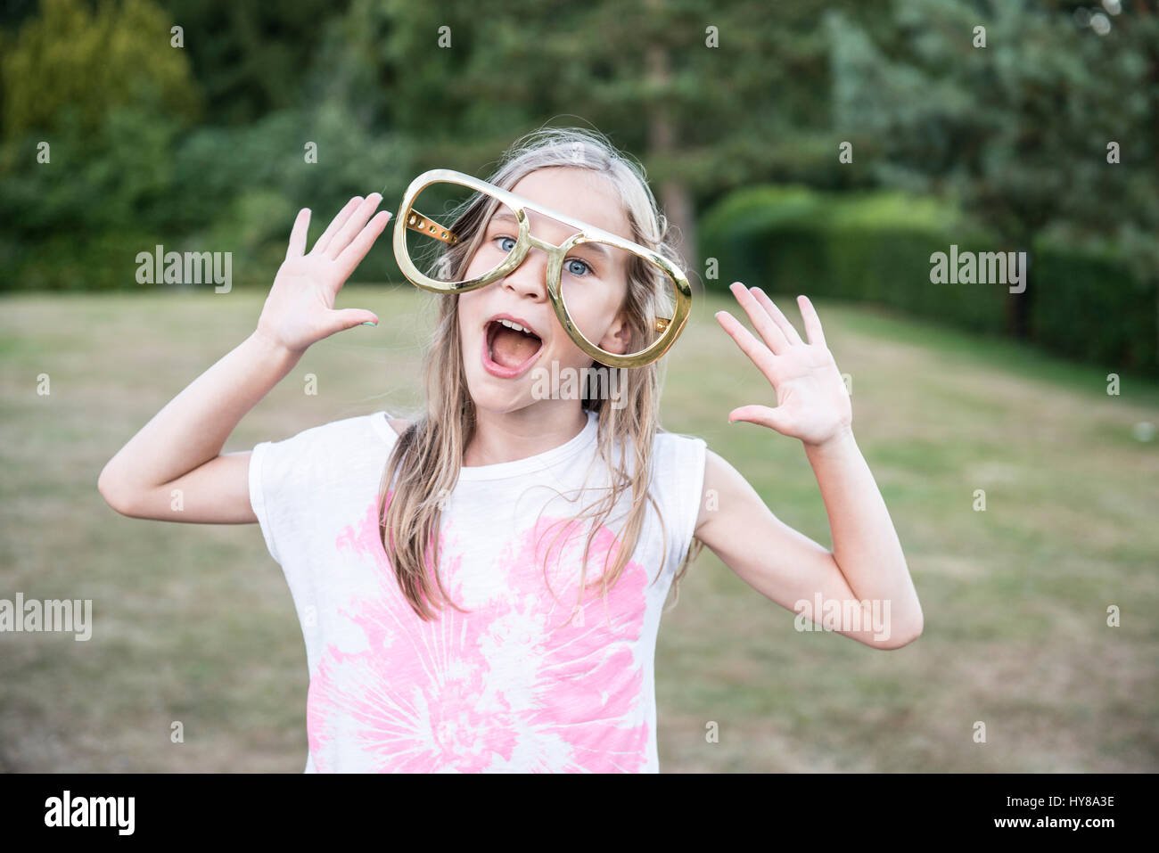A young girl wearing oversized joke glasses Stock Photo