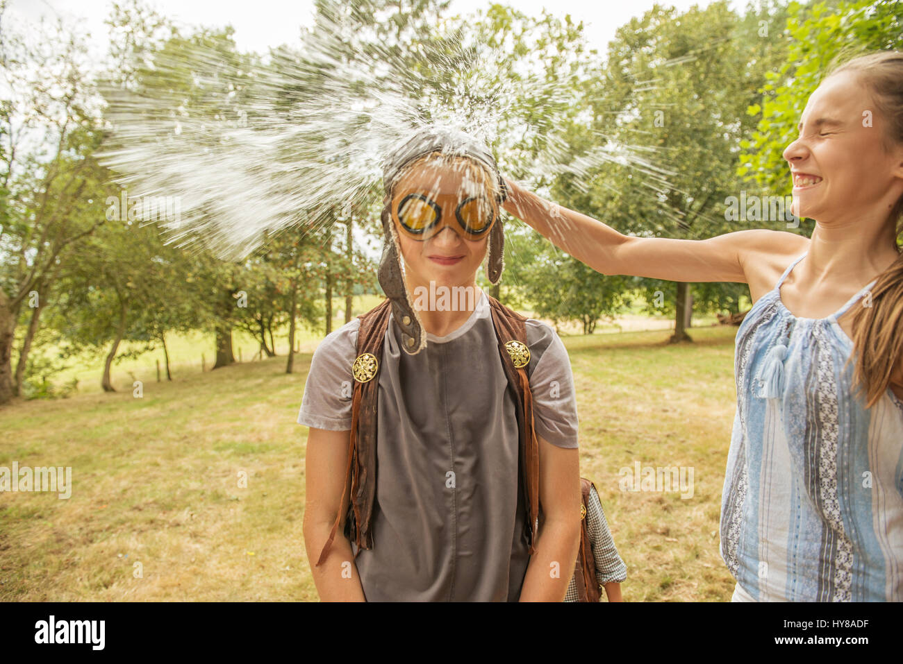 Young children play games outside in the sunshine Stock Photo