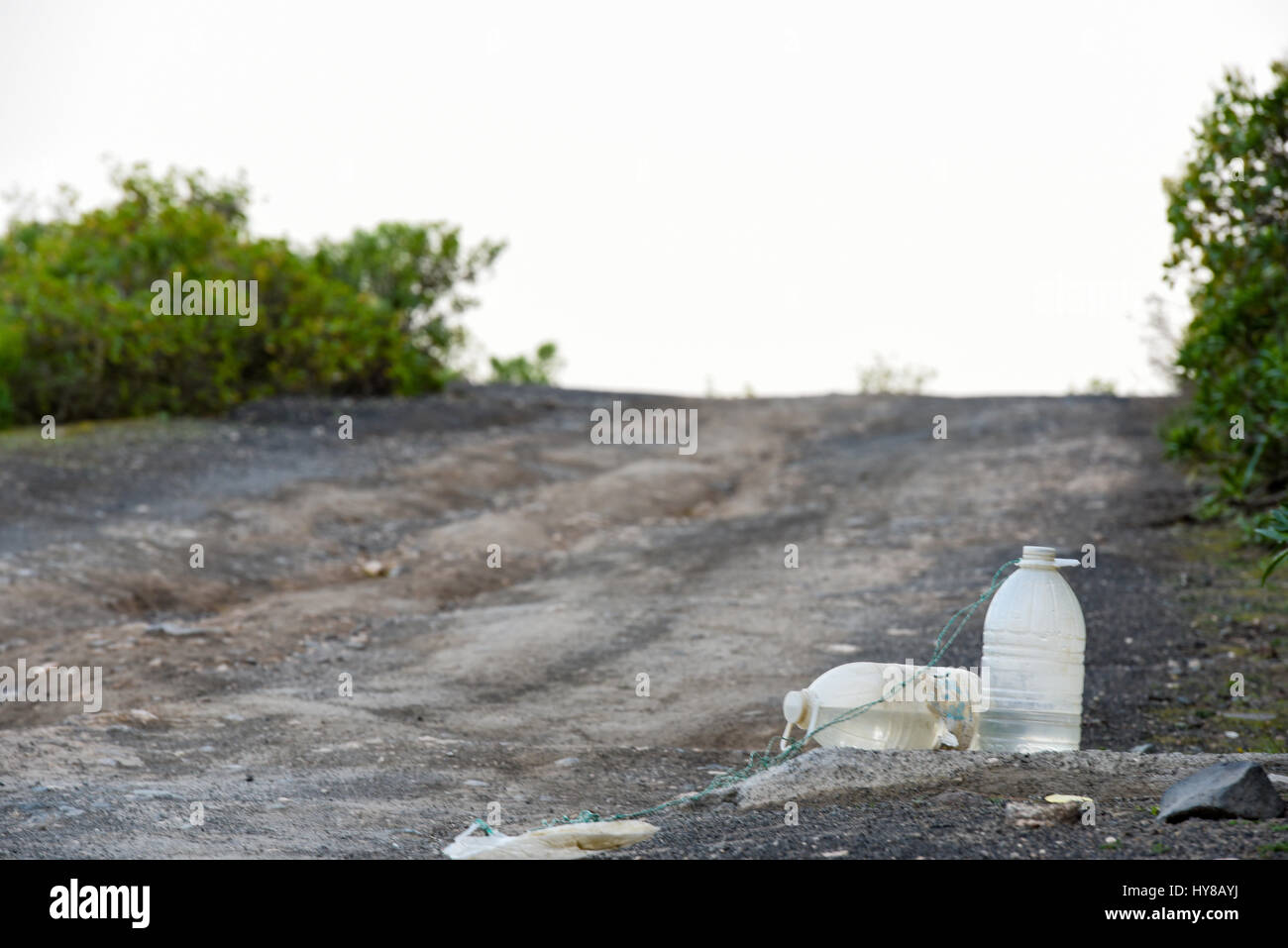 Plastic bottles with a water on a mountain road Stock Photo