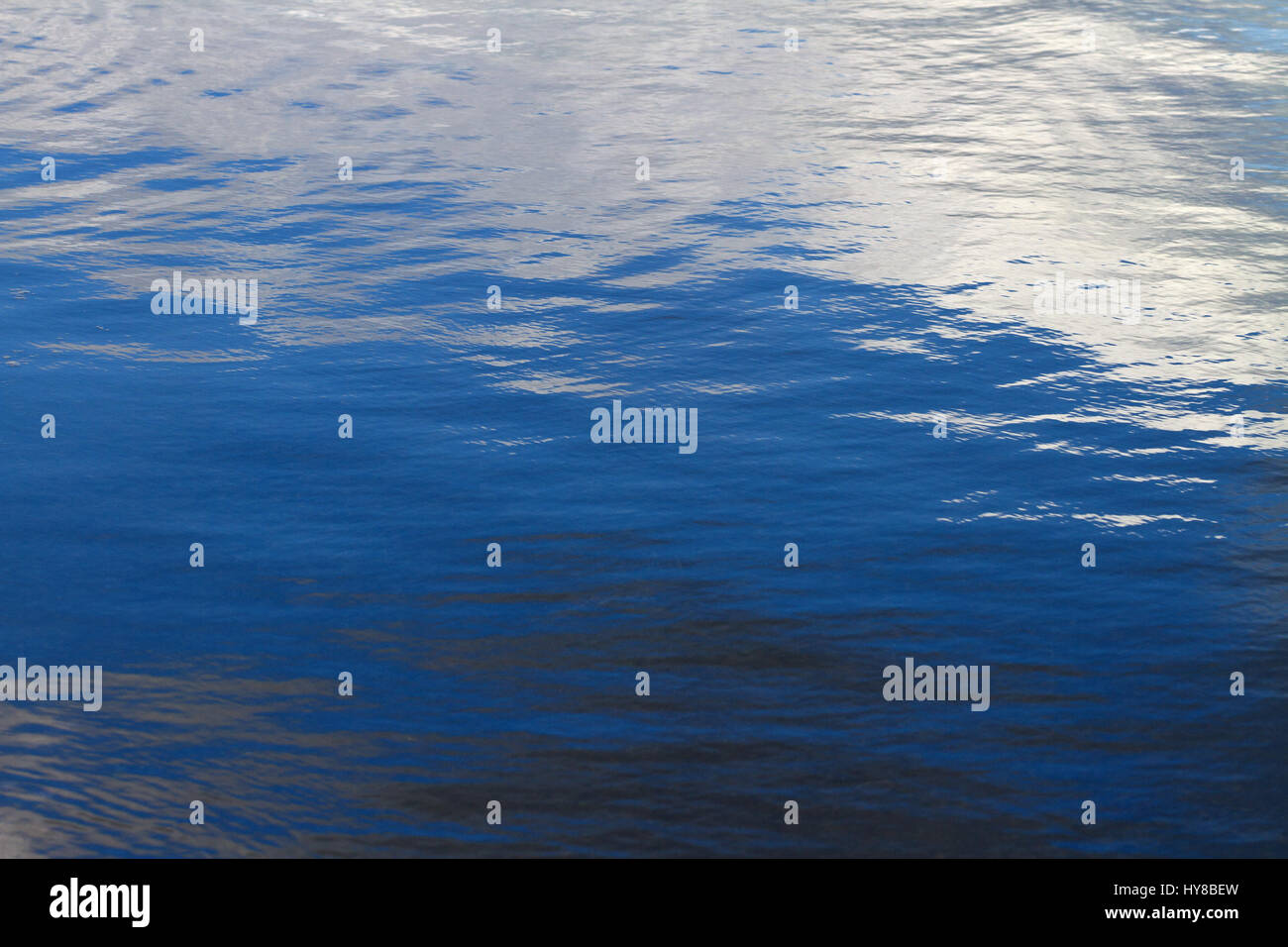 Surface of a blue water with ripples Stock Photo - Alamy