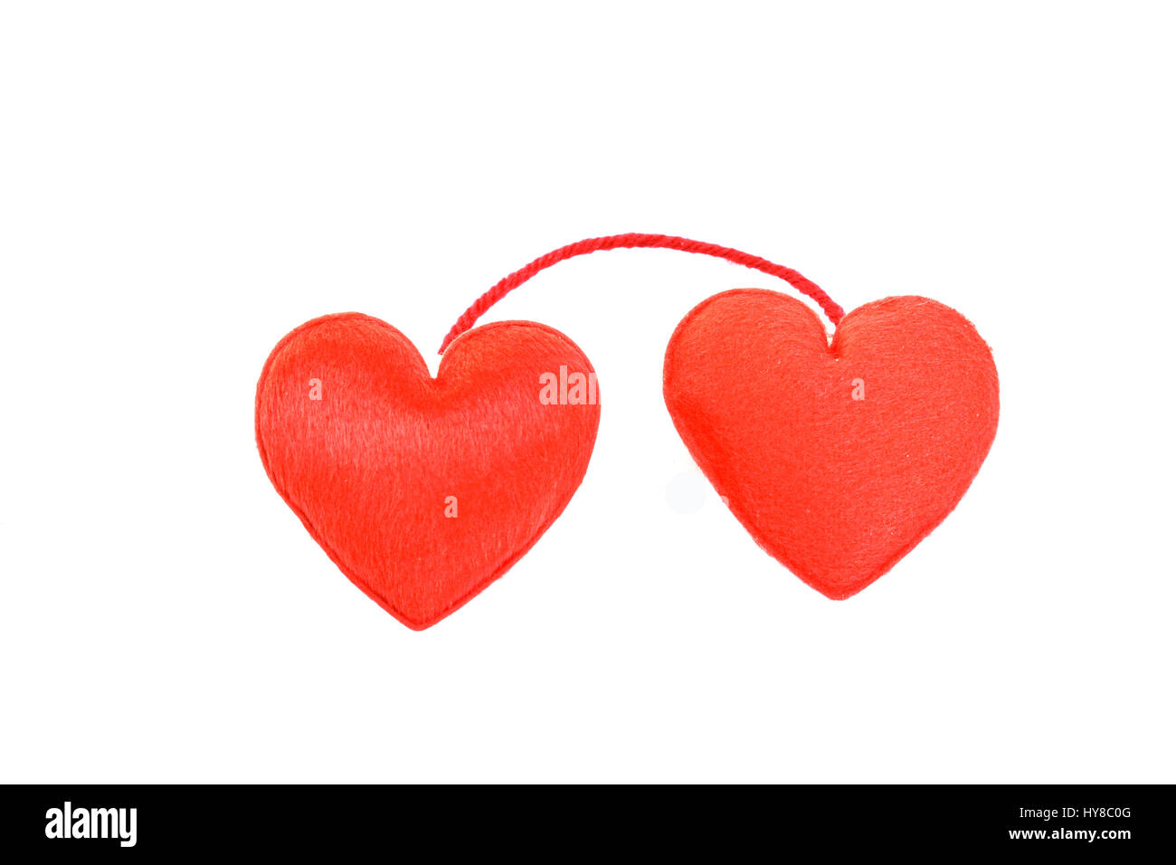 Two red hearts in love on white background Stock Photo - Alamy