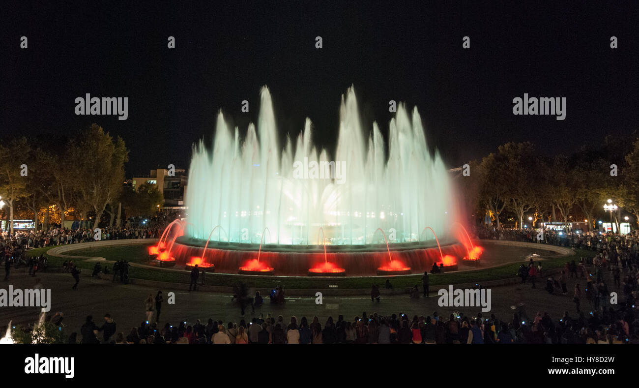 People attend colourful light & water fountain show. Night at the Magic ...