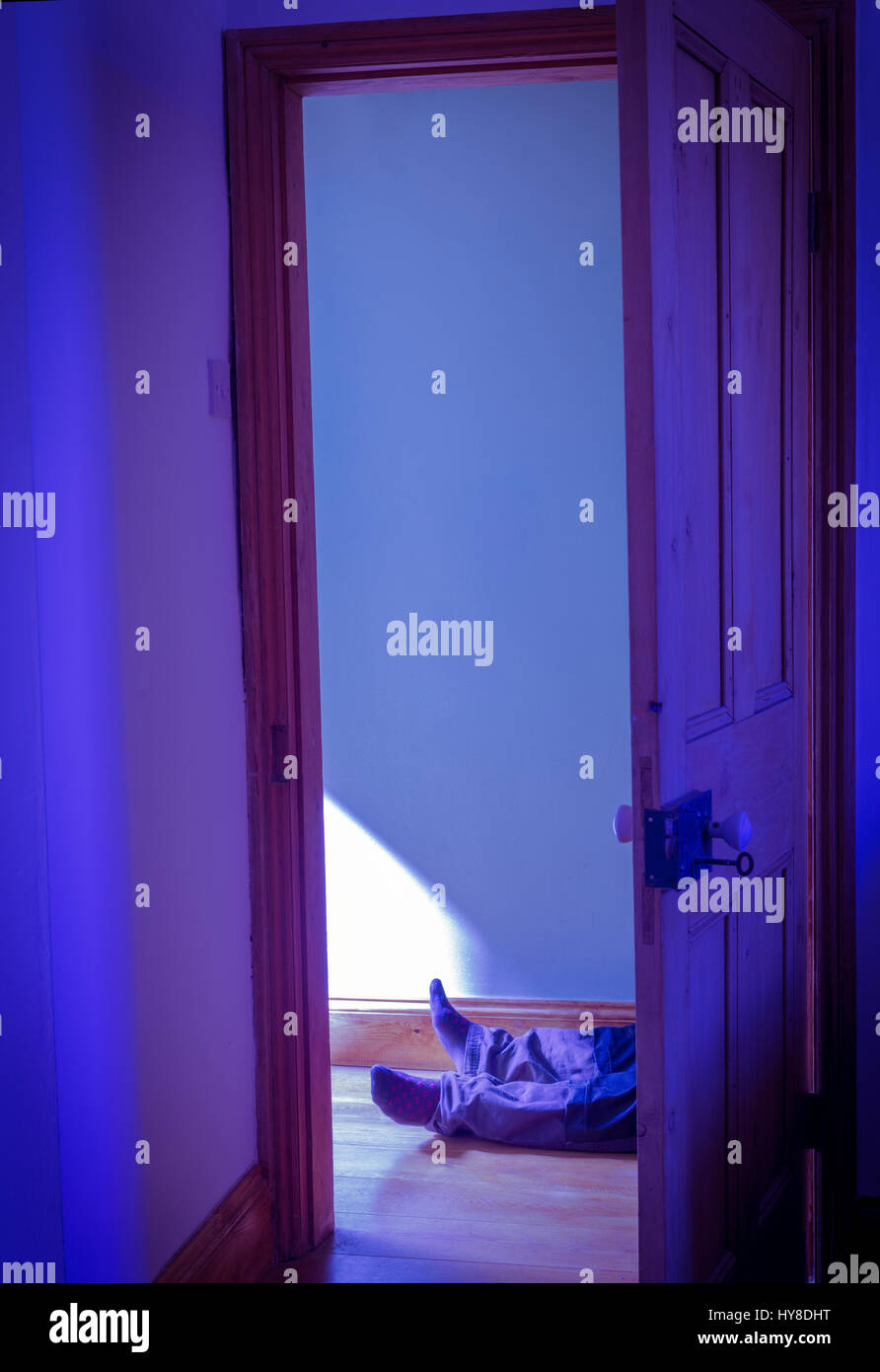Man laid on floor in hallway of house Stock Photo - Alamy