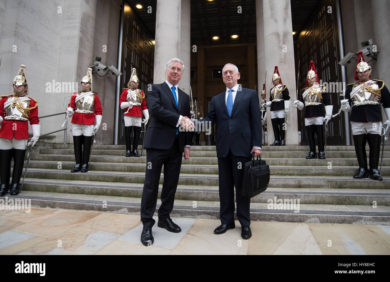 U.S. Secretary of Defense Jim Mattis is welcomed by British Defence Minister Sir Michael Fallon, left, for the arrival ceremony at the Ministry of Defence in Whitehall March 31, 2017 in London, United Kingdom. Stock Photo