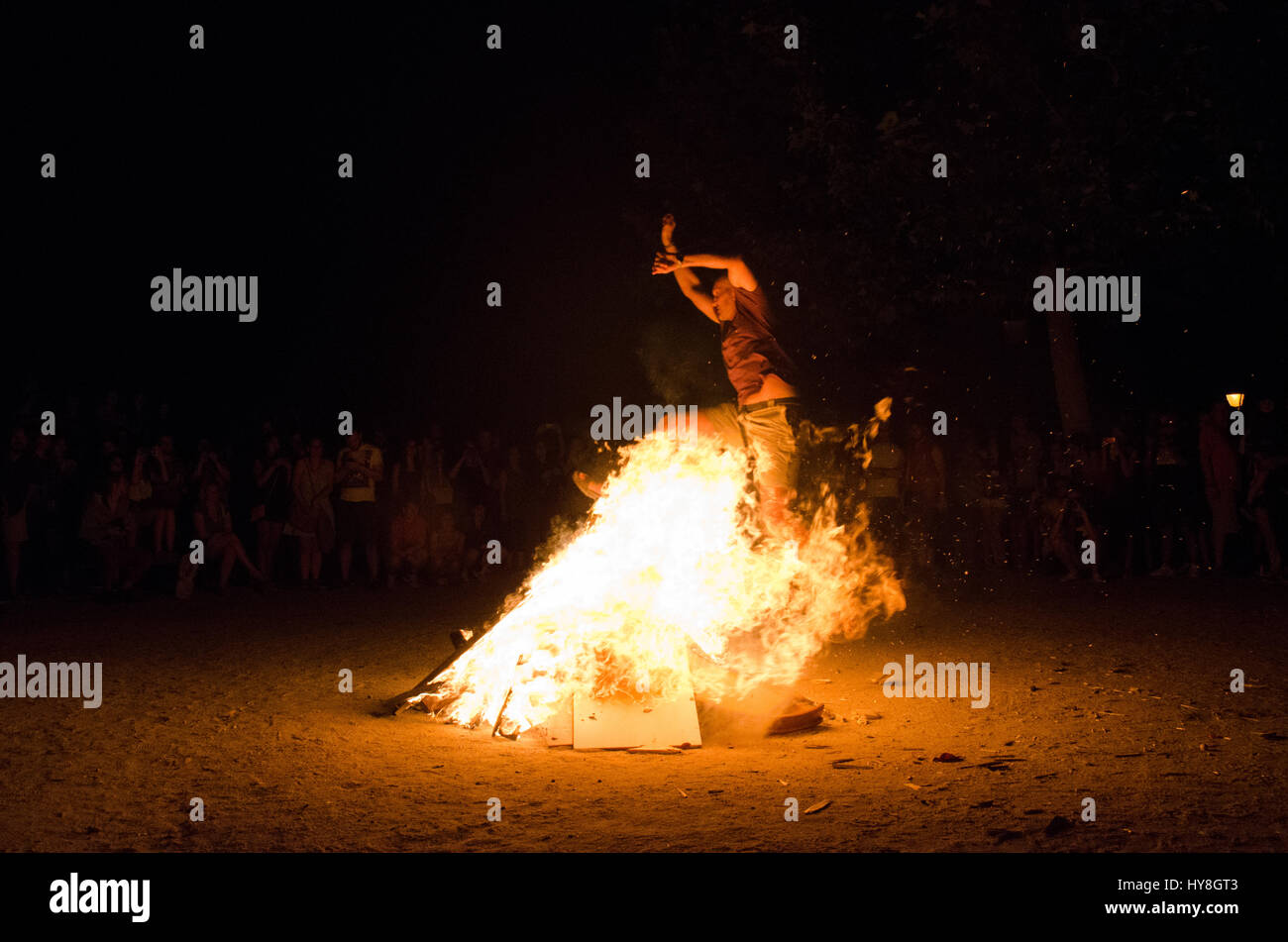 A man jumping through the fire of a bonfire during Saint John's Eve in Madrid Stock Photo Alamy