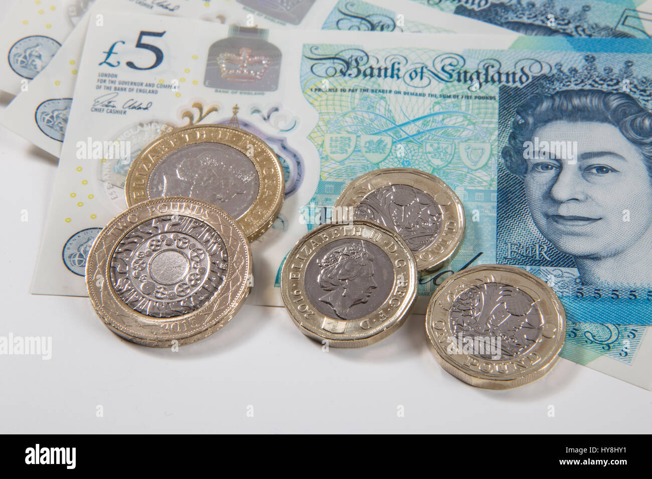 New £1 pound coins, £2 pound coins and £5 pound notes Stock Photo