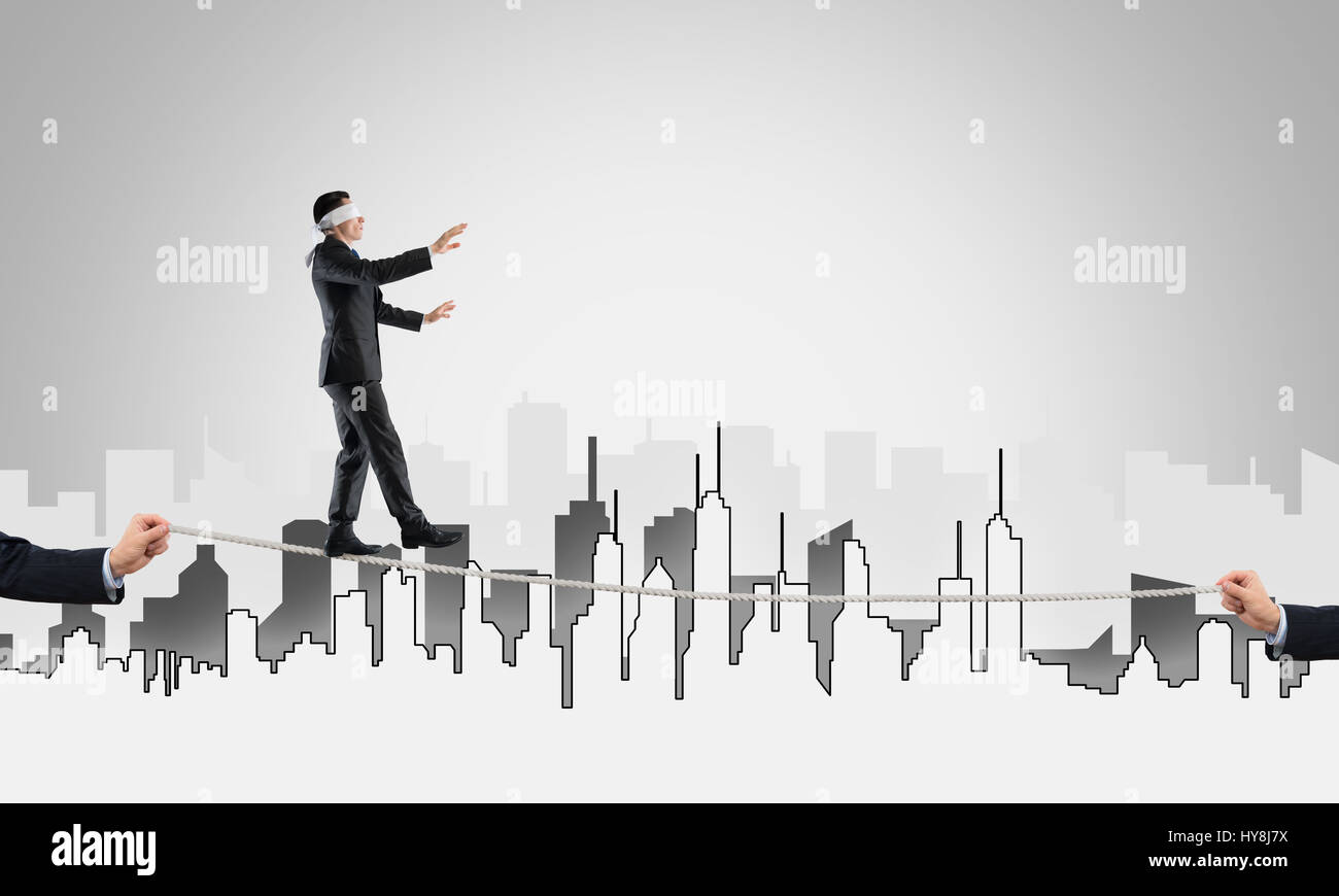 Business concept of risk support and assistance with man balancing on ...