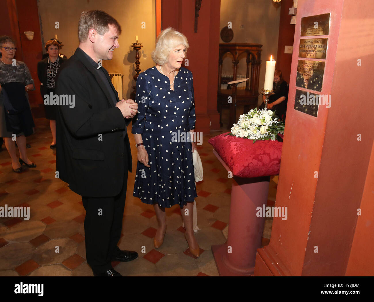 The Duchess of Cornwall with the Reverend William Lister, Chaplain Area Dean for Italy and Malta (left) during a visit to St Mark's Anglican Church in Florence, Italy, where she lay flowers at a memorial plaque in honour of Alice Keppel, the Duchess of Cornwall's great-grandmother. Stock Photo