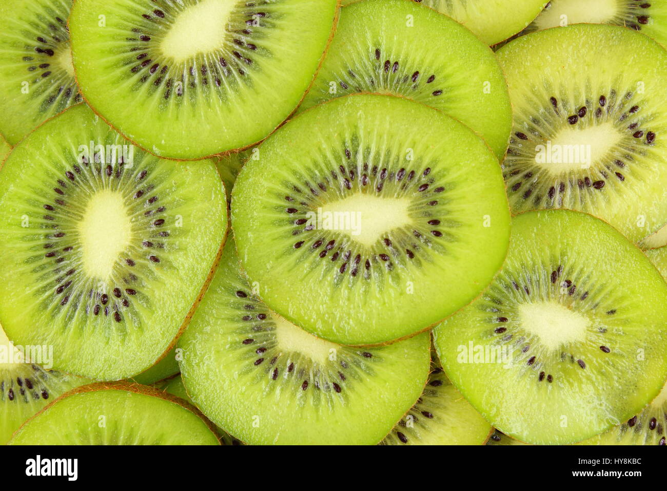 slices of fresh green kiwi fruits as a food background texture Stock Photo