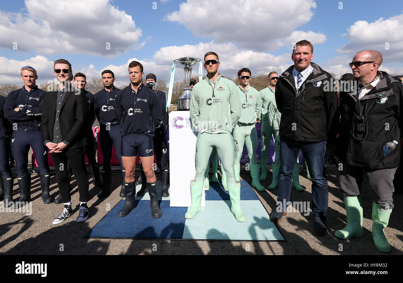 Mens crew pose for a picture after the coin toss is performed prior to the Men's Boat Race on the River Thames, London. Stock Photo