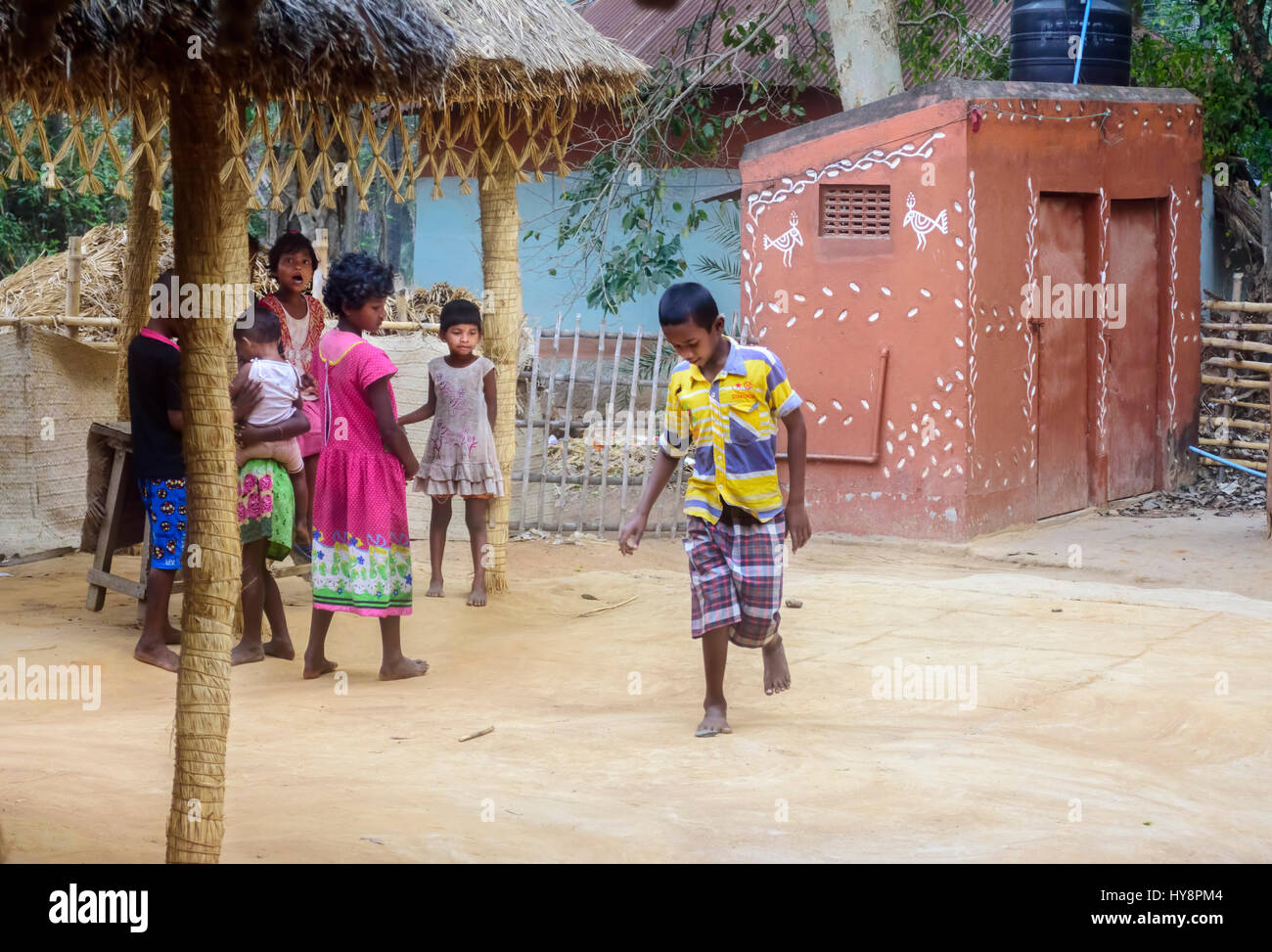 Village boys and girls playing traditional game called kitkit in the