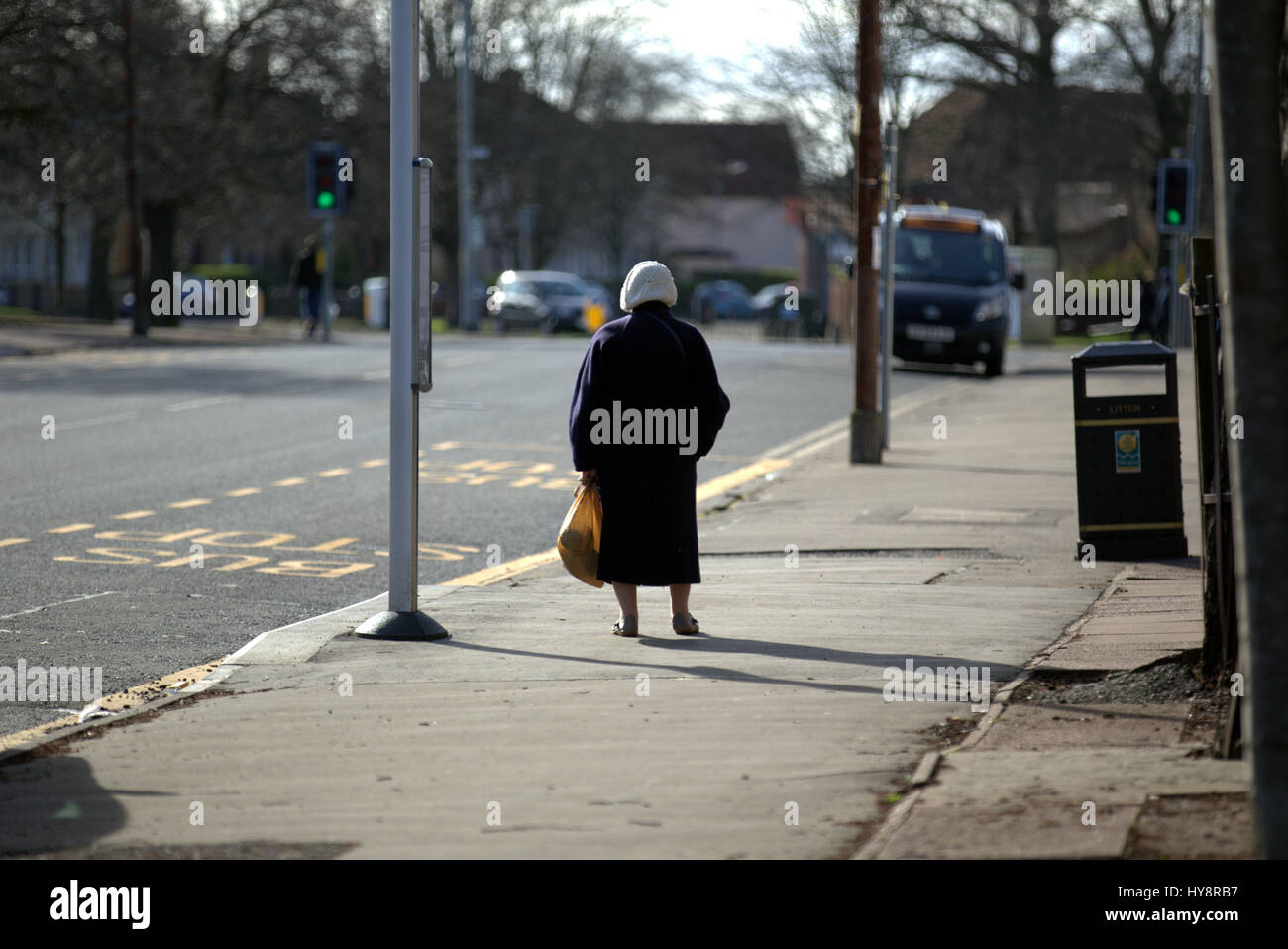 granny at a bus stop isolated Stock Photo