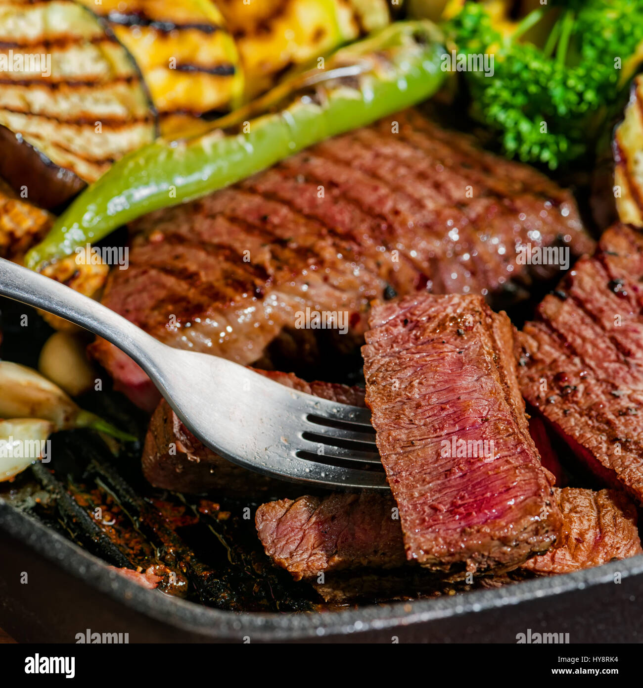slicing delicious roasted meat on fork with vegetable,  healthy lifestyle Stock Photo