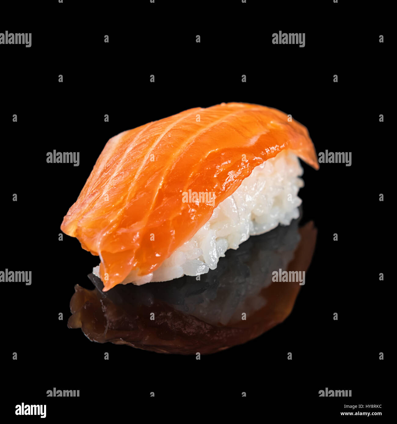 Japanese classic sushi nigiri with salmon isolated on black background with reflection, close up Stock Photo