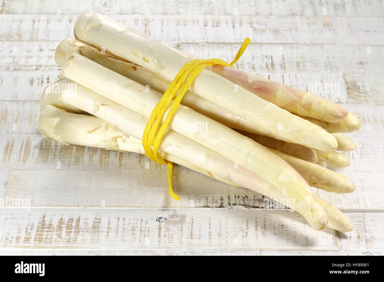 bundle of white asparagus on wooden background Stock Photo