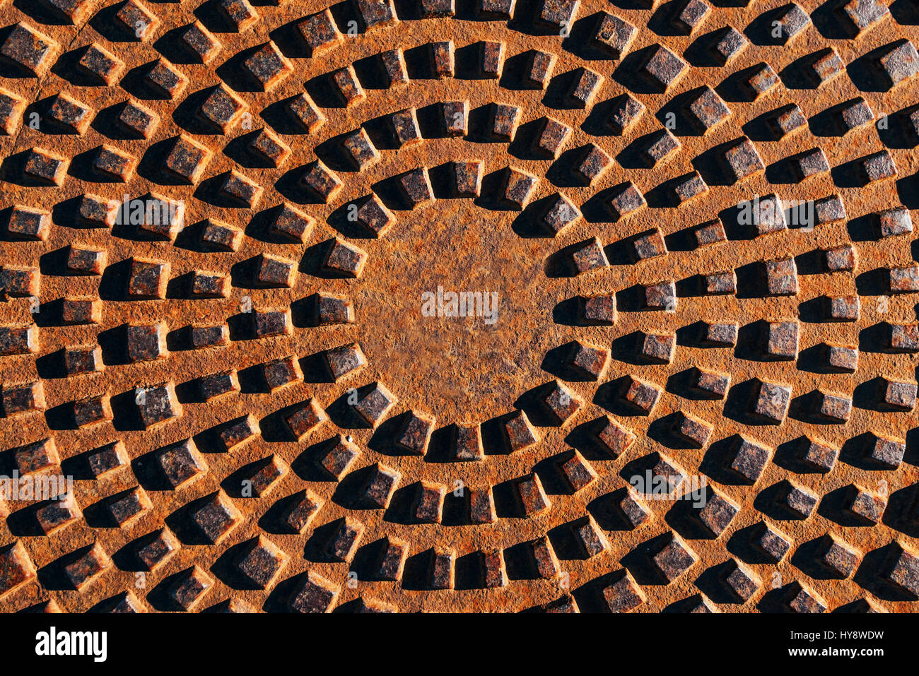 Concentric pattern on corroded manhole cover, top view of abstract ...