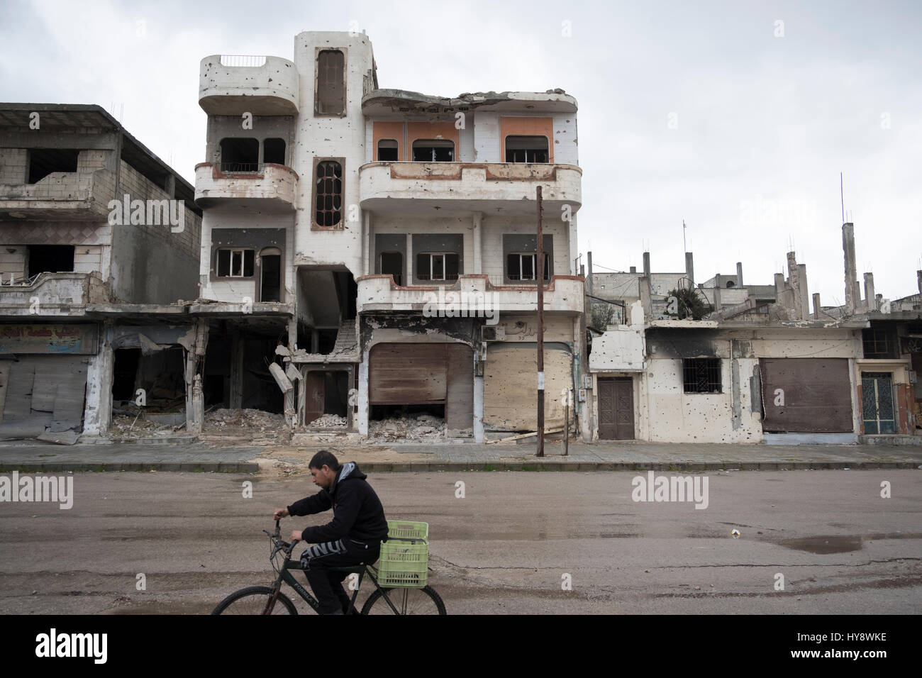 Bicycler in distressed district Baba Amr in Homs, Syria in early 2017 Stock Photo