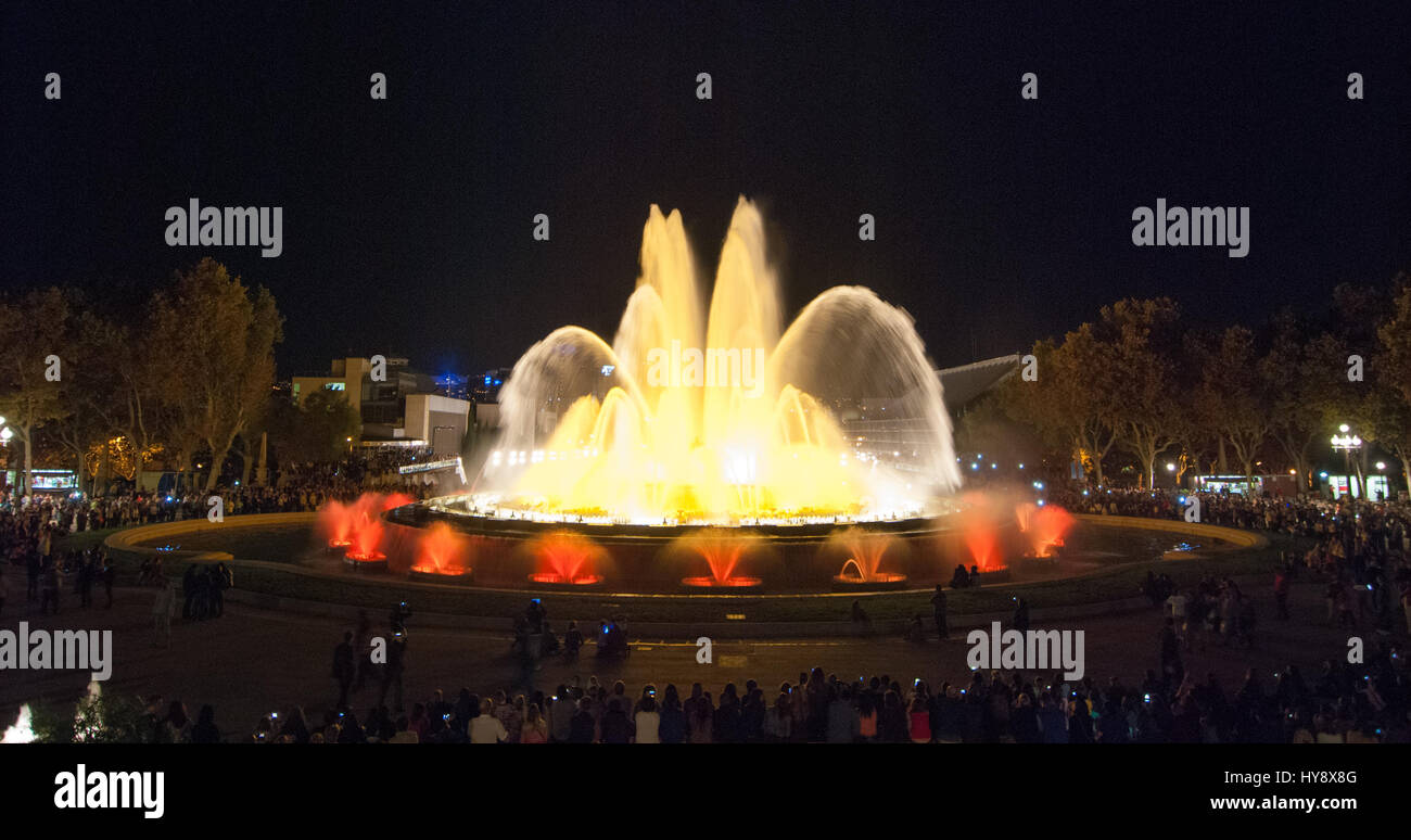 People attend colourful light & water fountain show. Night at the Magic ...