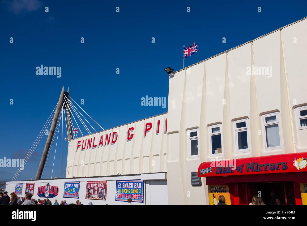 Funland arcade building on Southport pier with Marine Way suspension bridge in background Stock Photo