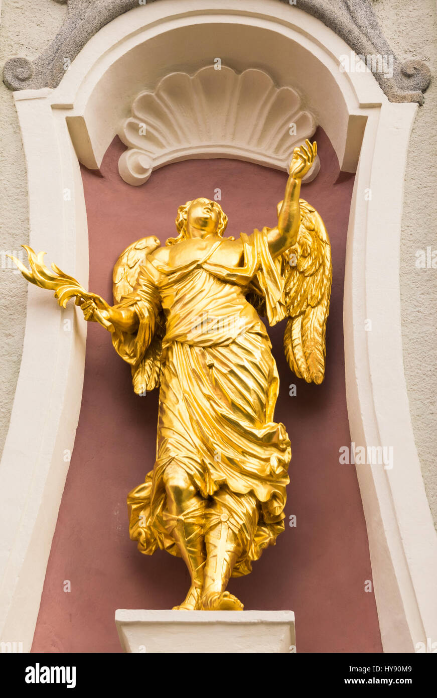 San Candido, Italy - December 25, 2016: Angel golden statue on the facade of an Italian church. Stock Photo