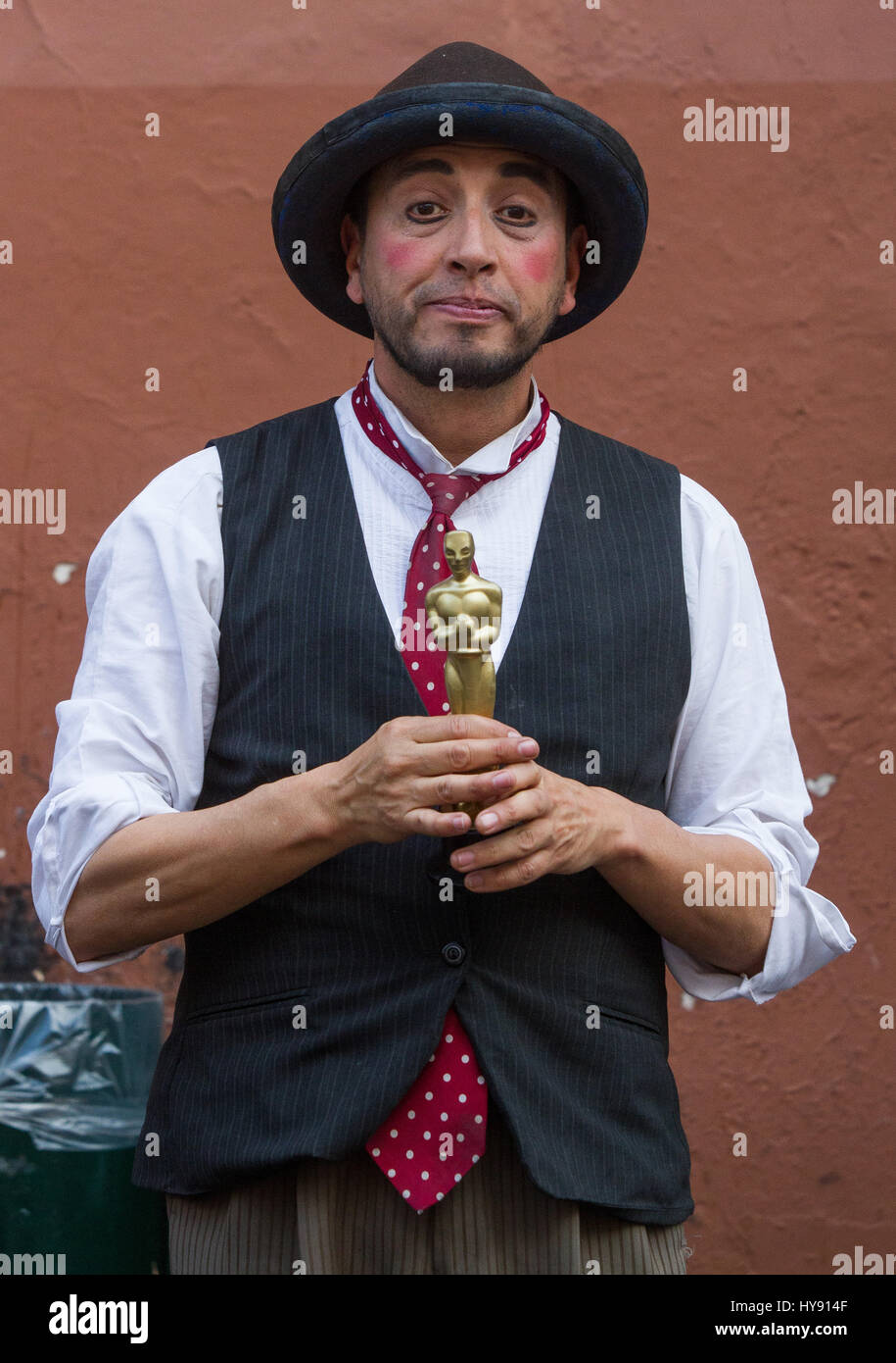 An actor showing a fake Oscar Statue Award Stock Photo