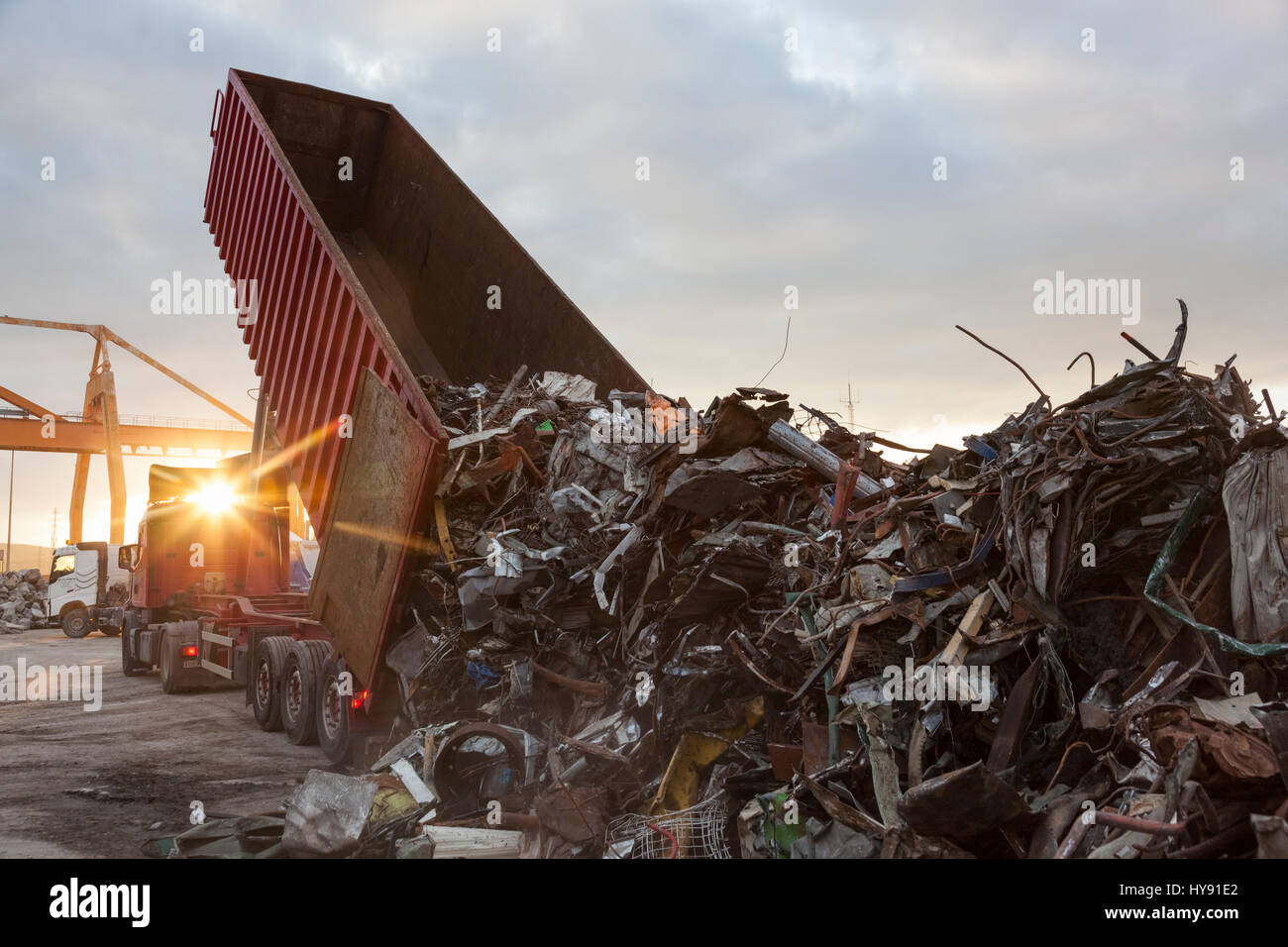 A truck unloads its cargo of scrap metal prior to shipment to a recycling facility Stock Photo