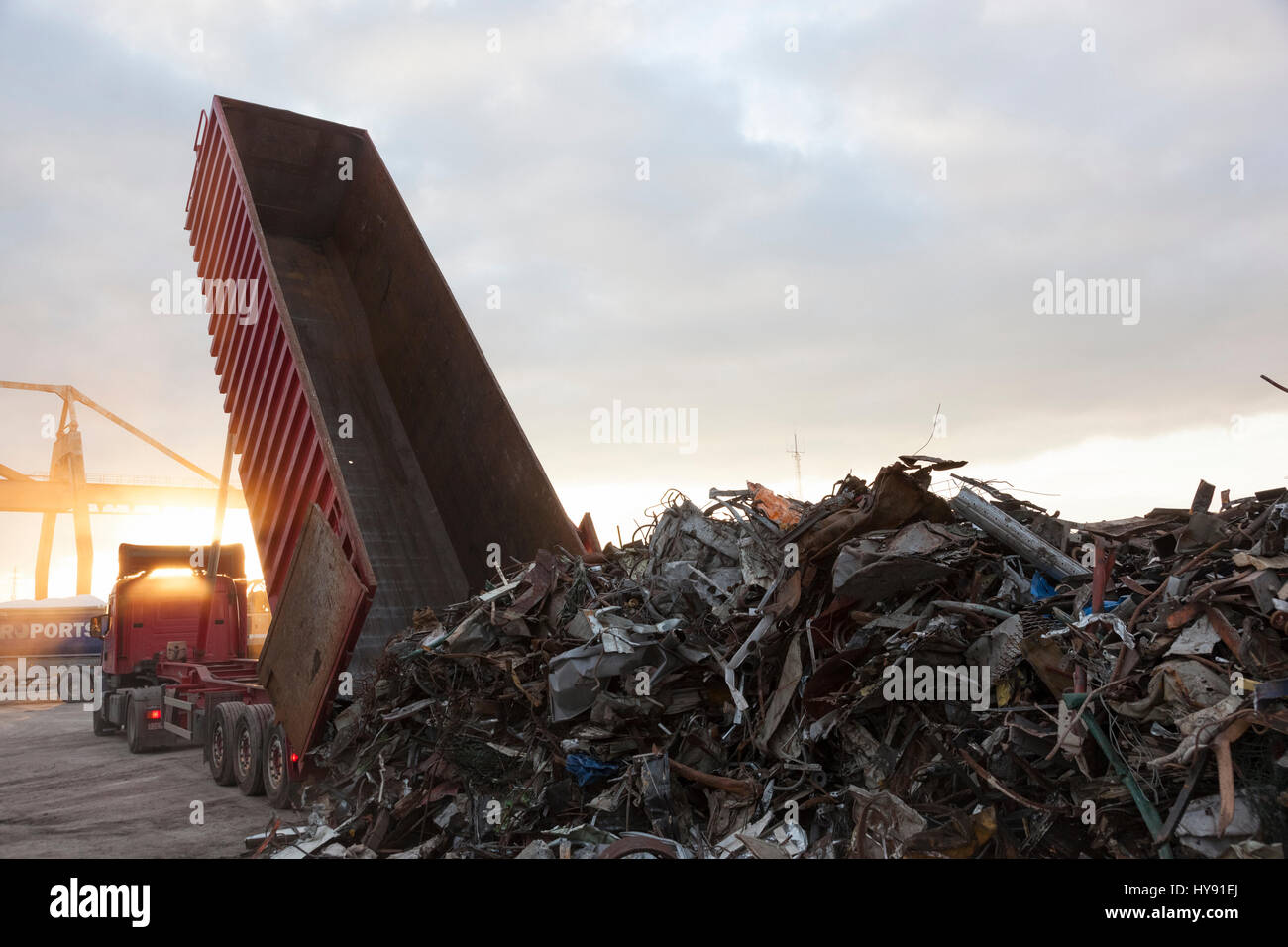 A truck unloads its cargo of scrap metal prior to shipment to a recycling facility Stock Photo