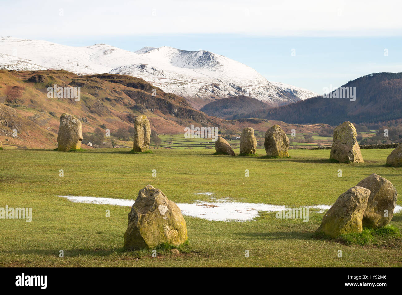 A snow capped Helvellyn seen from Castlerigg Stone Circle near Keswick, Cumbria, England, UK Stock Photo