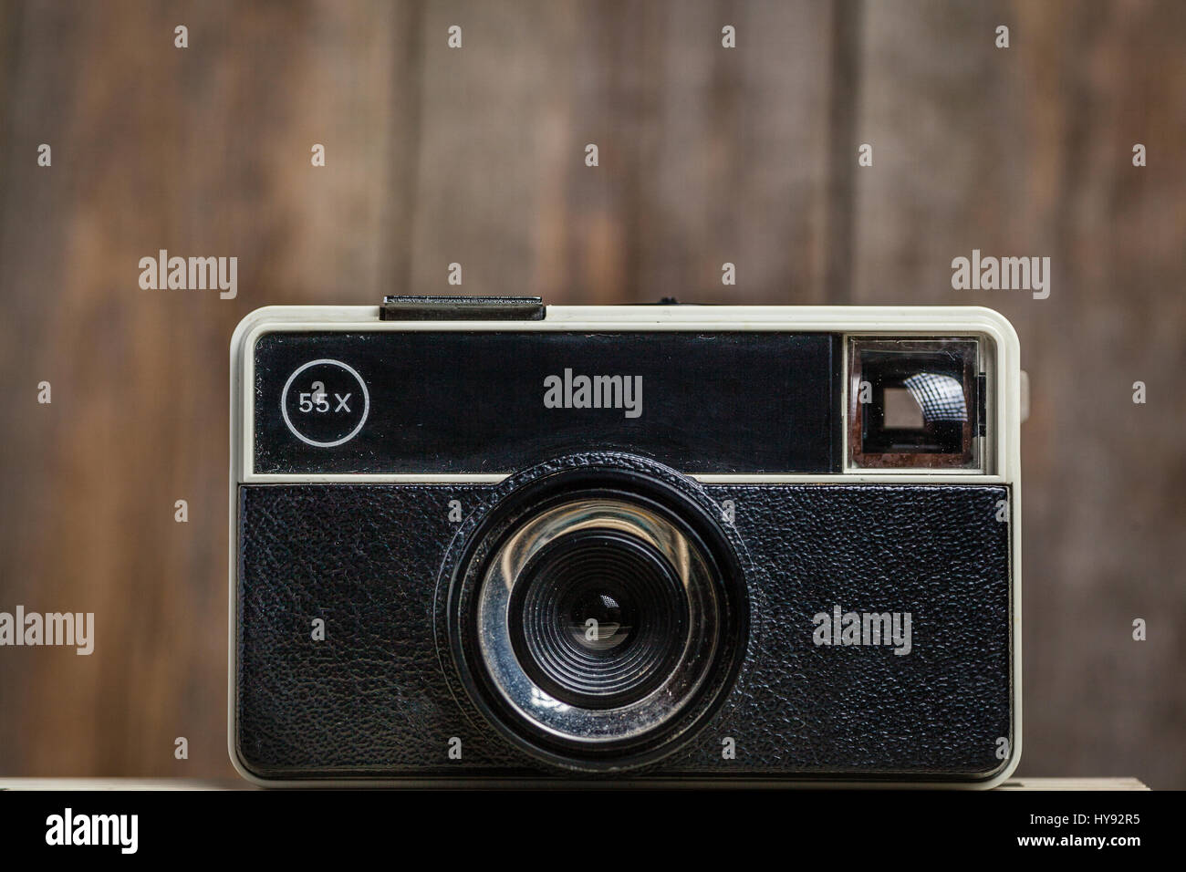 Old vintage instamatic camera on a wooden background Stock Photo Alamy