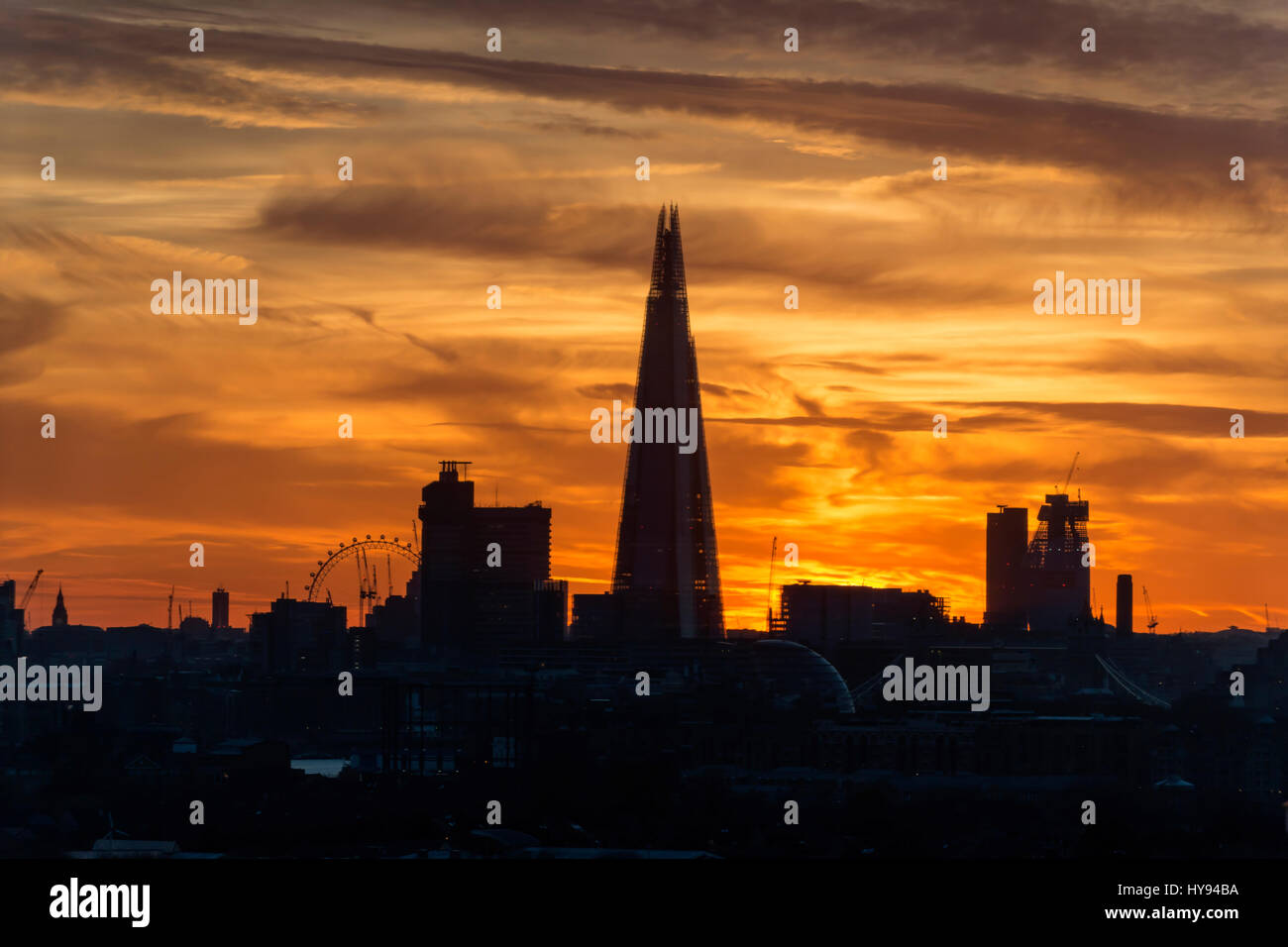 London Skyline at Dusk with Shard Building and London Eye in Silhouette. Stock Photo