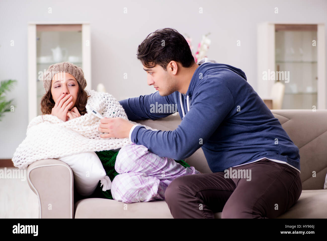 Husband caring for sick wife Stock Photo - Alamy