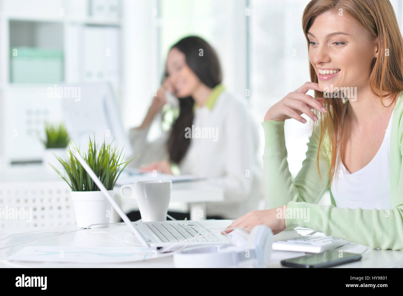 Portrait of a nice business woman with a laptop Stock Photo - Alamy