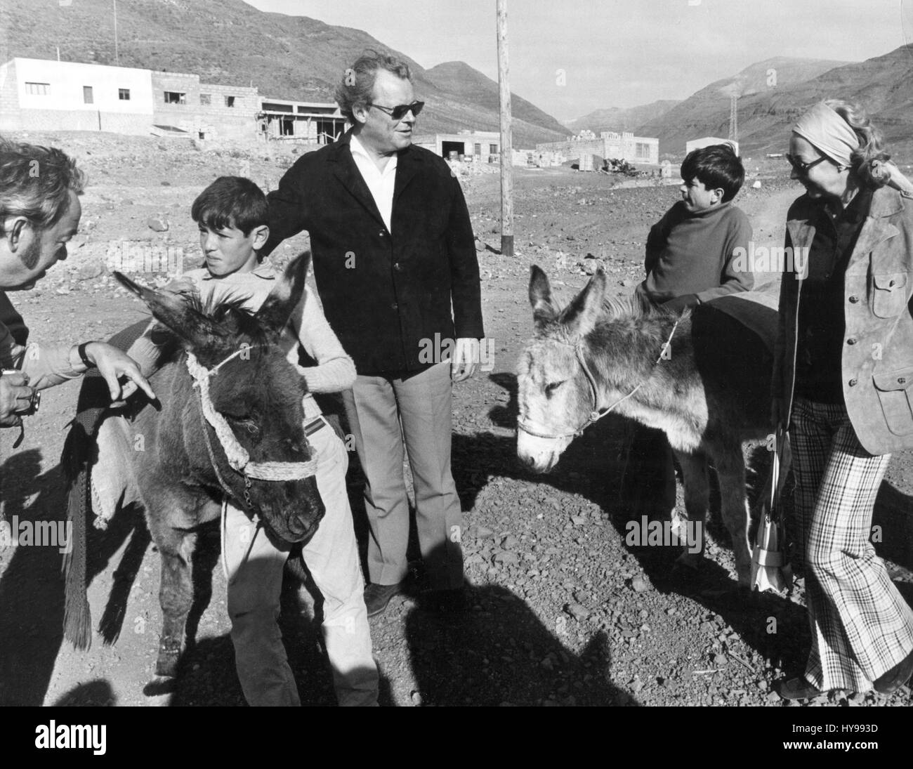 German Federal Chancellor Willy Brandt (M) and his wife Rut (R) ride on donkeys during a trip to the mountains in January 1973. Brandt and his family spend a three weeks holiday on Fuerteventura, Spain. | usage worldwide Stock Photo