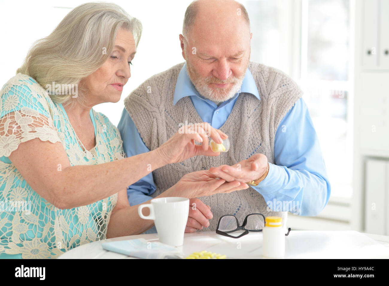 Elderly couple with pills Stock Photo