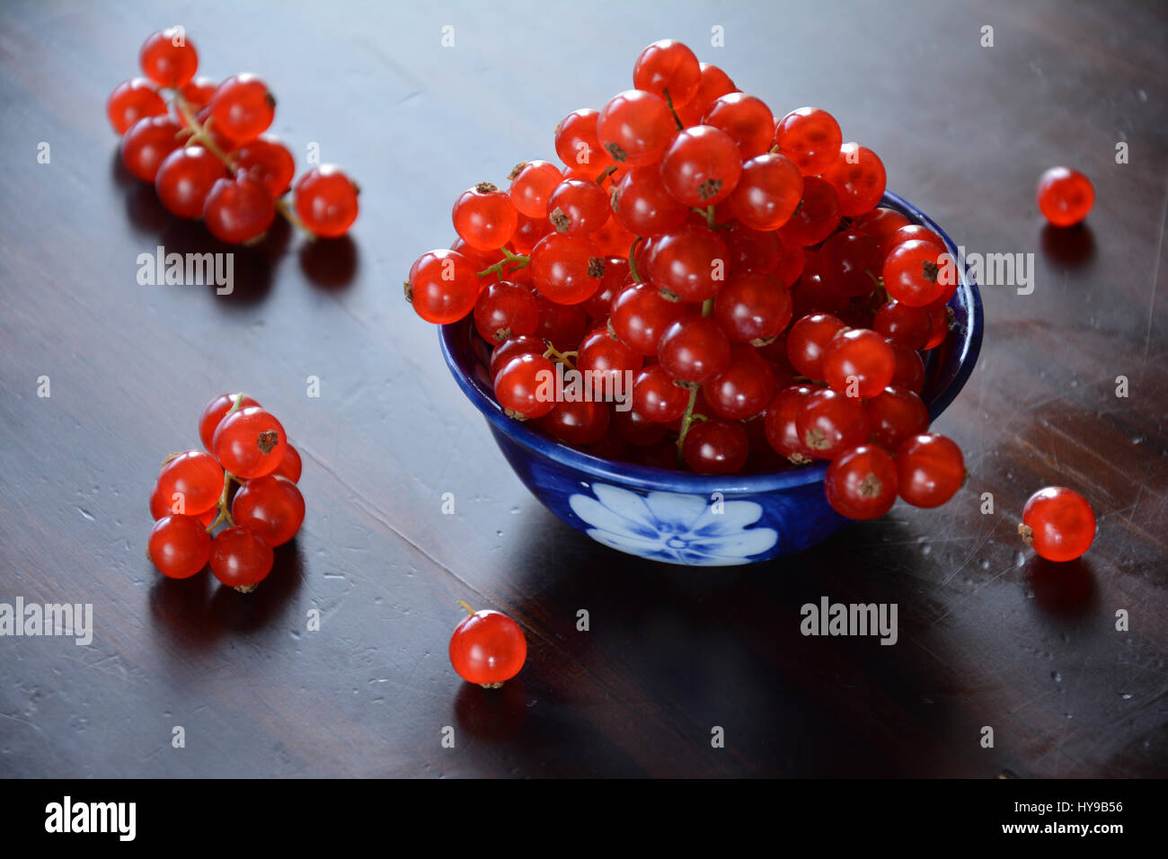 Against the light view of redcurrant berries in a ceramics bowl Stock Photo