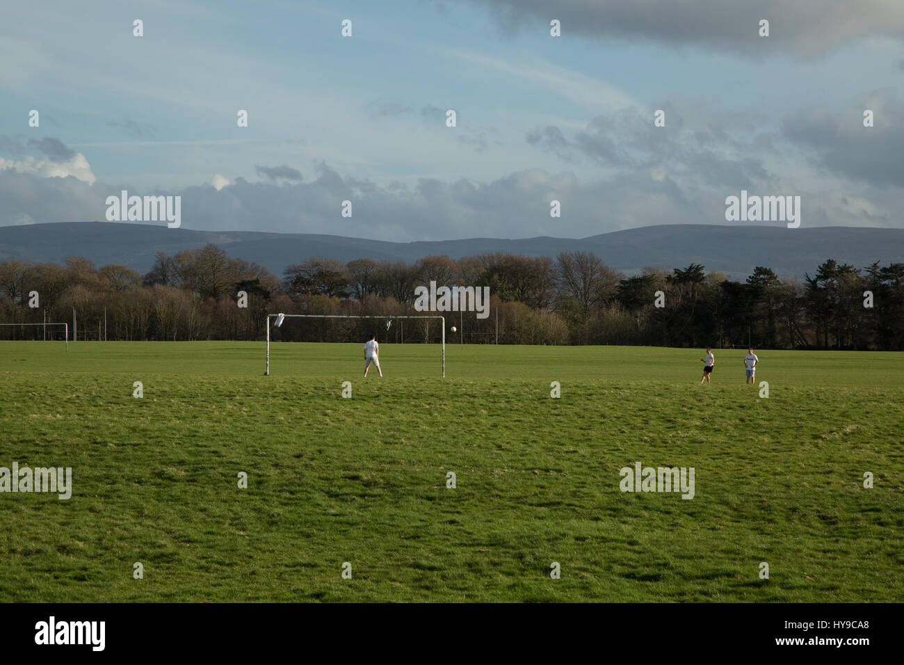 Young men playing football in the Phoenix park, Dublin city, Ireland. Stock Photo