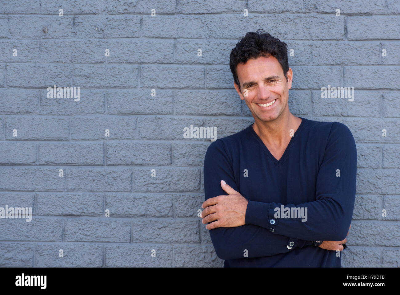 Close up portrait of a smiling older guy with arms crossed Stock Photo ...