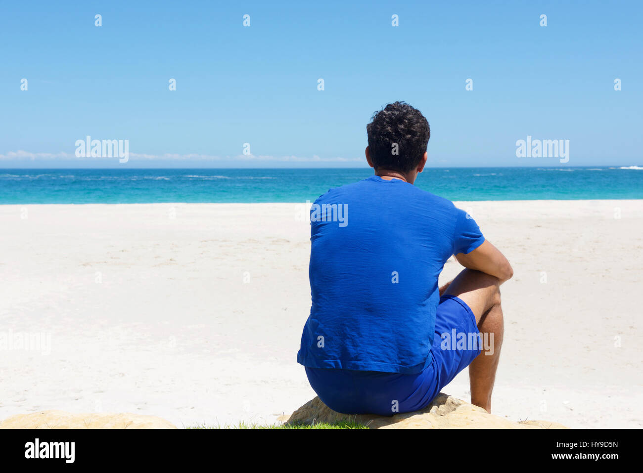 Man alone sitting rear view hi-res stock photography and images - Alamy