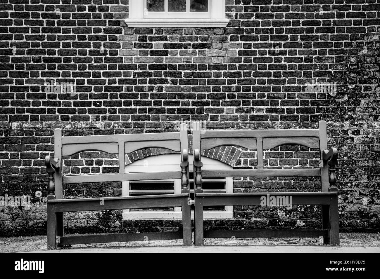 Two benches on the side of an old Virginia building. Stock Photo