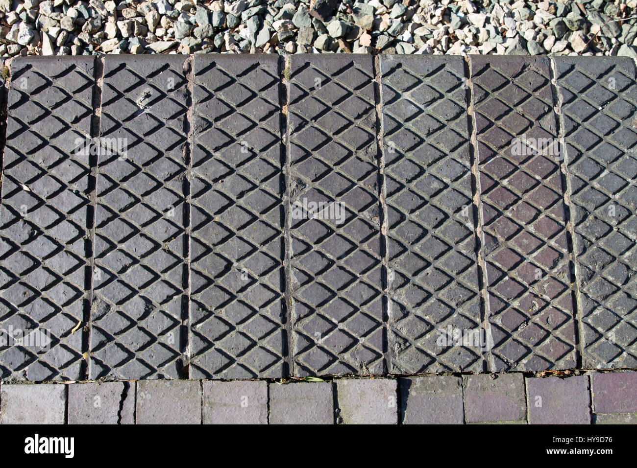 Patterns in the original Great Western Railway platform edge blocks at Welshpool Railway Station. Stock Photo