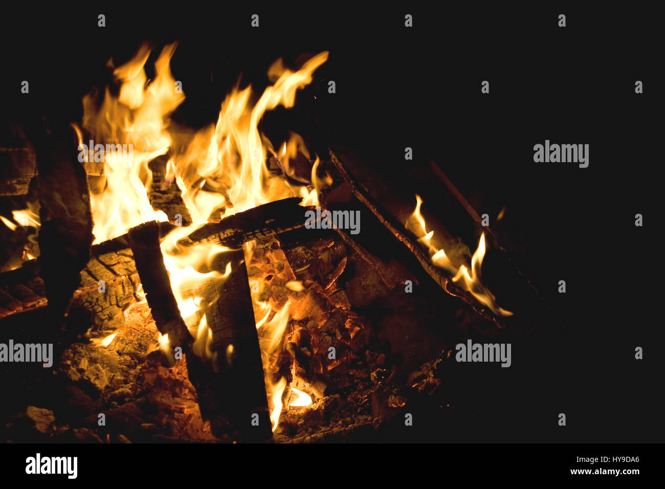 Flames of a campfire against a black background at night. Stock Photo