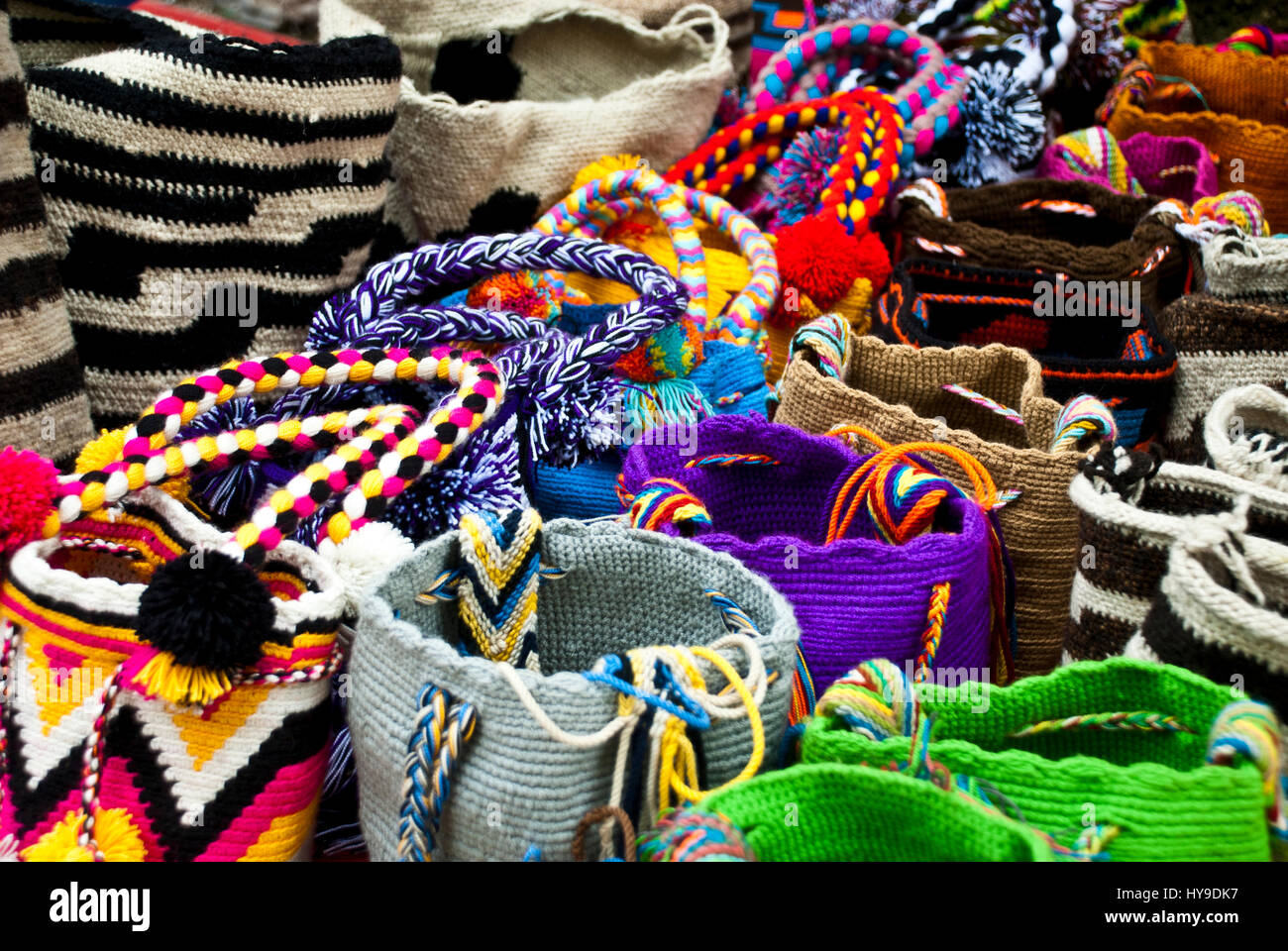 Women fashion accessories, Various items of crocheted bucket-style handbags, Wayuu handcrafted mochilas woolen bags, Colombia - street market Stock Photo