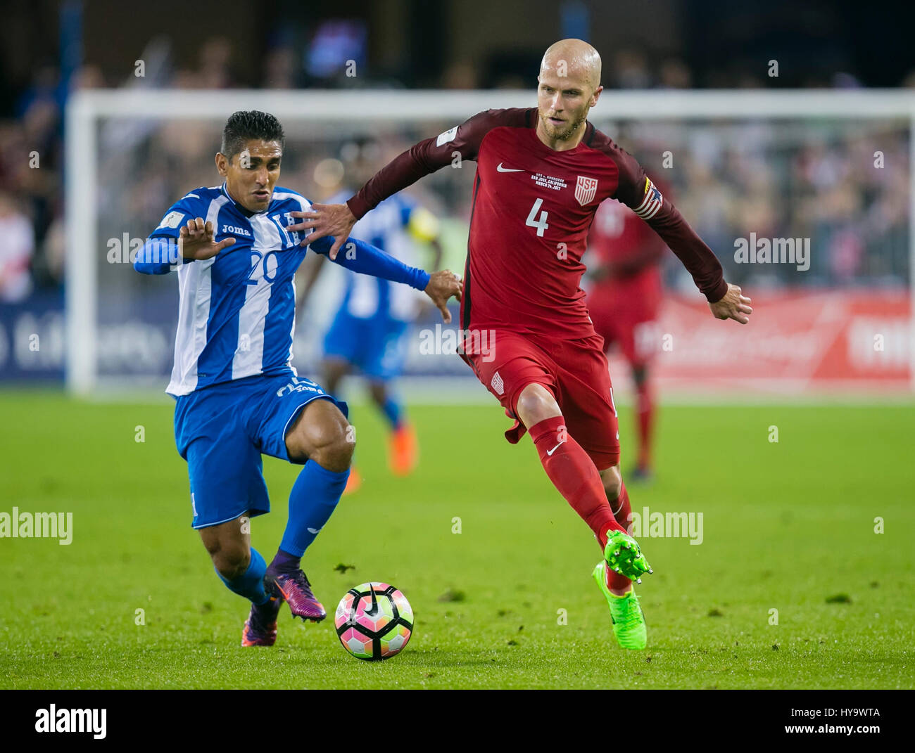 San Jose, CA. 24th Mar, 2017. US midfielder Michael Bradley (4) fights for possession with Honduras midfielder Jorge Claros (20) during the FIFA World Cup Qualifying game between the United States and Honduras at Avaya Stadium in San Jose, CA. The US defeated Honduras 6-0. Damon Tarver/Cal Sport Media/Alamy Live News Stock Photo