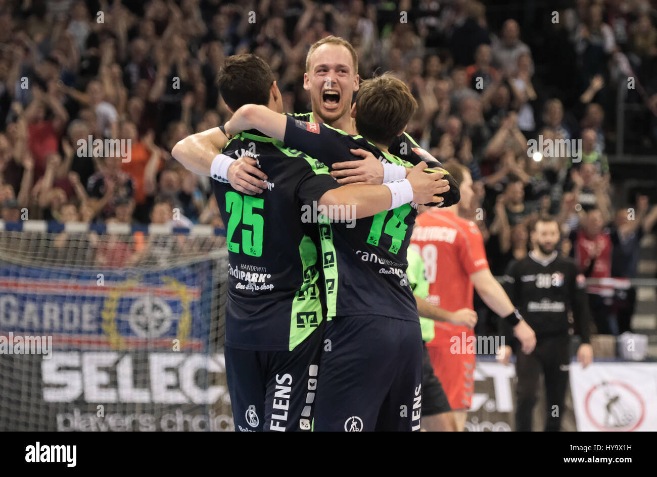 Flensburg's Rasmus Lauge (l-r), Henrik Toft-Hansen and Hampus Wanne celebrate the victory after the Handball Champions League knock-out round quarterfinals qualification second leg match between SG Flensburg-Handewitt and HC Brest at the Flens-Arena in Flensburg, Germany, 2 April 2017. Photo: Axel Heimken/dpa Stock Photo