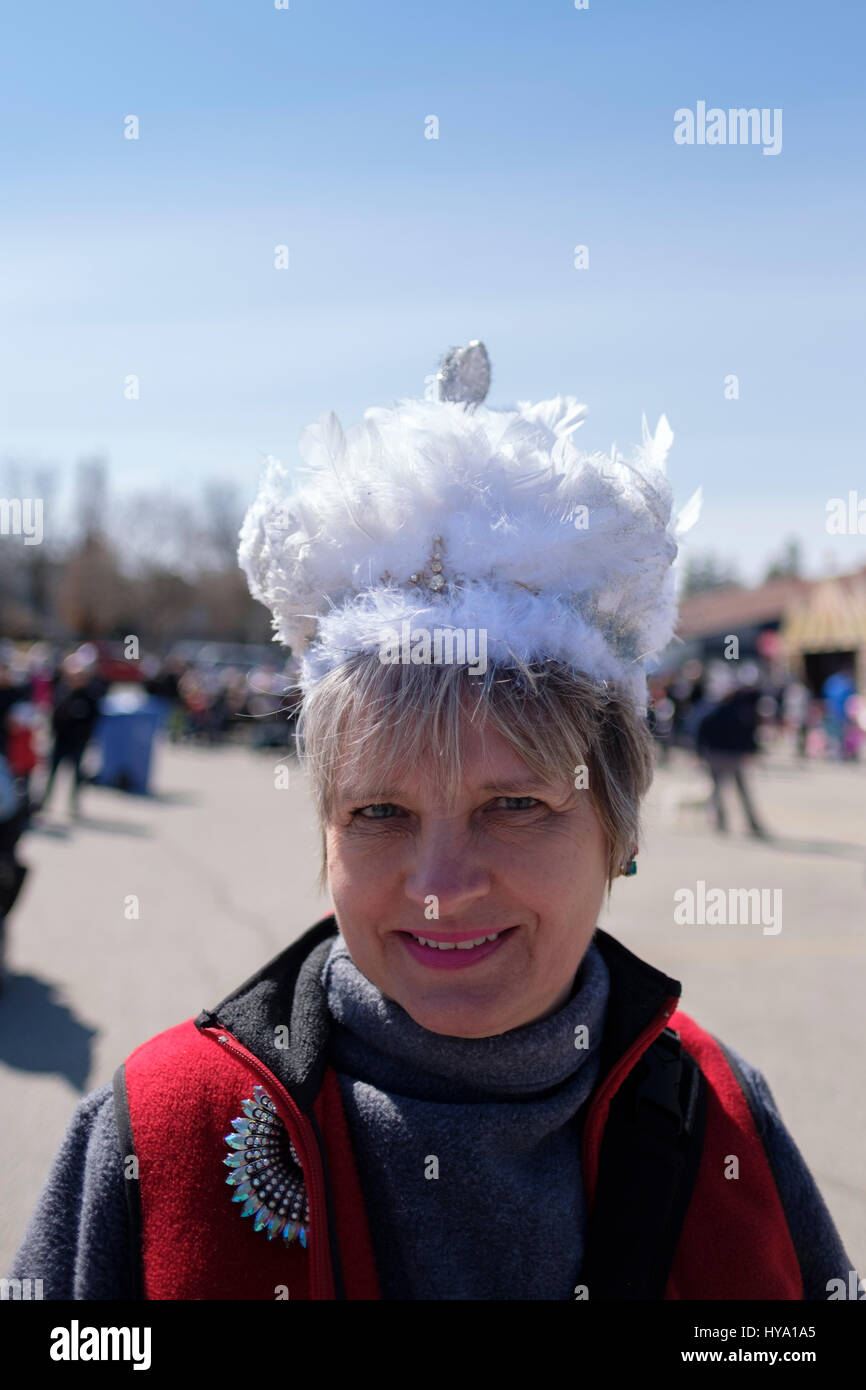 Stratford, Ontario, Canada, 2nd Apr, 2017. Middle aged woman wearing a decorated hat in the shape of a swan joins the Stratford's Annual Swan Parade, when the city's flock of mute swans (Cygnus olor) returns to the Avon River, in celebration of the arrival of Spring, in Stratford, Ontario, Canada. Credit: Rubens Alarcon/Alamy Live News. Stock Photo