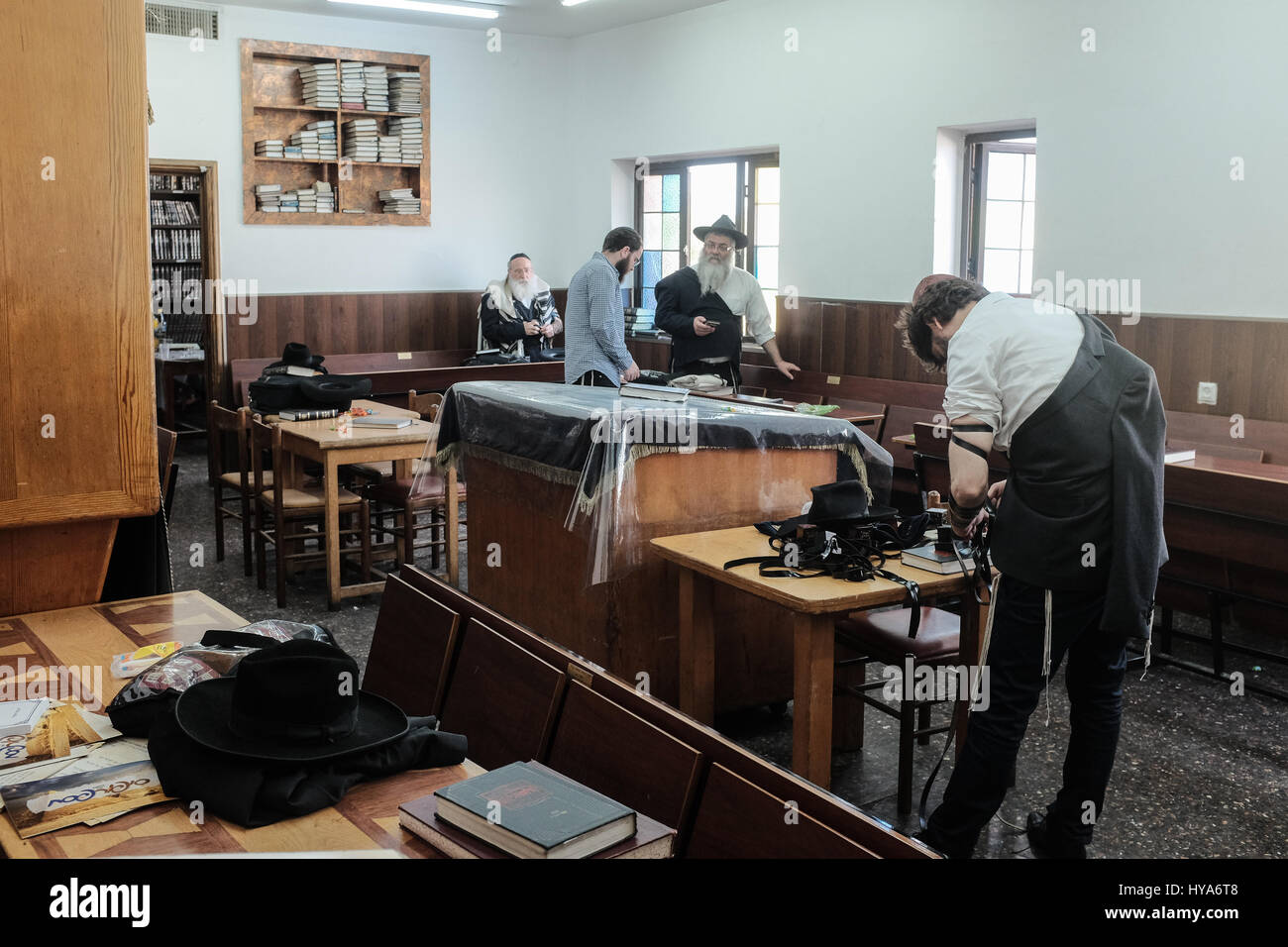 Kfar Chabad, Israel. 3rd April, 2017. Men pray in the synagogue in '770' in the village of Kfar Chabad. The building is a replica of '770', the Chabad headquarters at 770 Eastern Parkway, Crown Heights, Brooklyn, New York, and includes the exact number of bricks as on the original structure. Chabad Lubavitz is an Orthodox Jewish, Hasidic movement, founded in 1775 and last headed by Rabbi Menachem Mendel Schneerson (1902-1994) who transformed the small Hasidic movement into the largest and most influential Jewish movement in the world. In 1994, the 'Rebbe' was posthumously awarded the Congressi Stock Photo