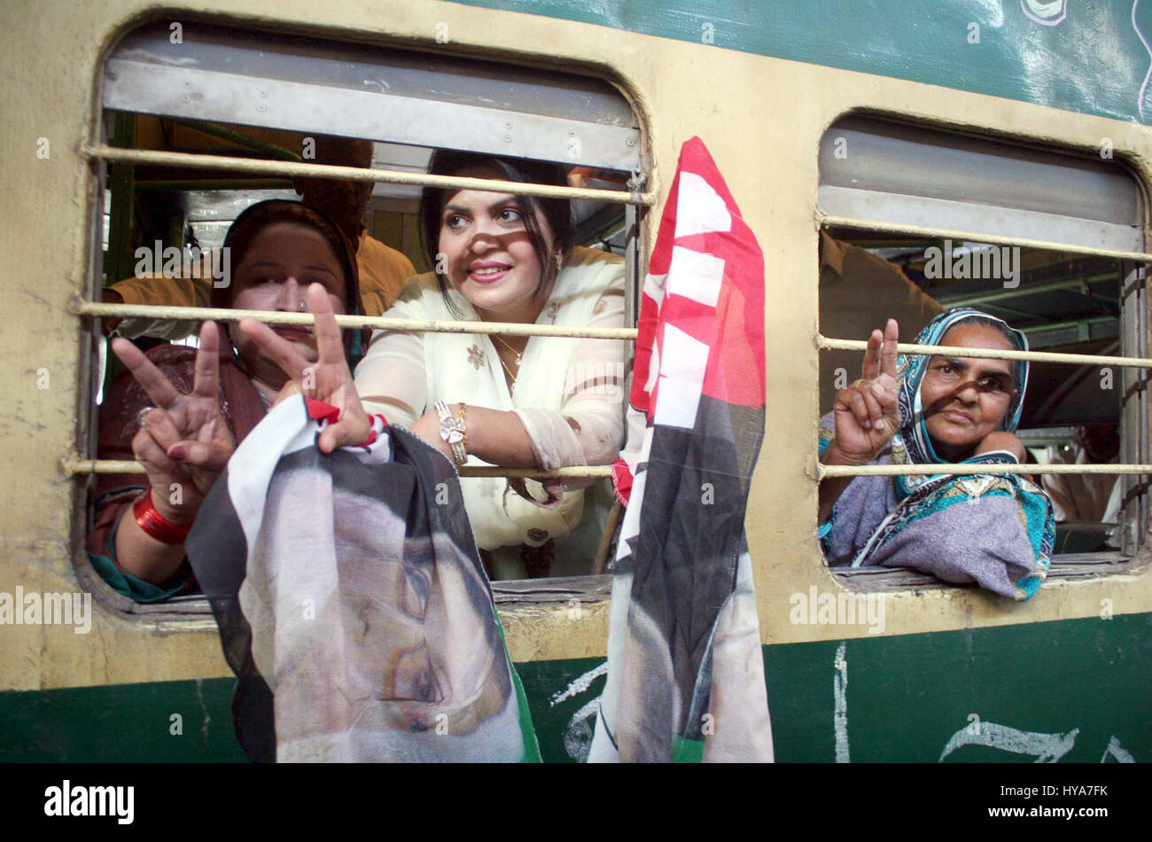 Activists of Peoples Party (PPP) chant slogans as they are leaving for Garhi Khuda Bux before their departure to attend the Death Anniversary ceremony of PPP Founder, Zulfiqar Ali Bhutto, at railway station in Lahore on Monday, April 03, 2017. Stock Photo
