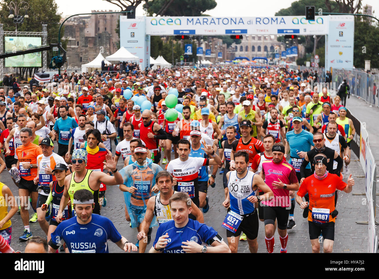 Rome, Italy. 02nd Apr, 2017. Rome, Italy - April 2, 2017: the departure of the athletes on Via dei Fori Imperiali, the Coliseum on background. Credit: Polifoto/Alamy Live News Stock Photo
